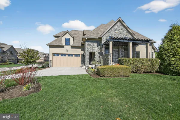 a front view of a house with a garden and plants