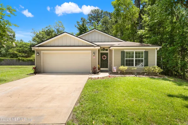a front view of house with yard and green space