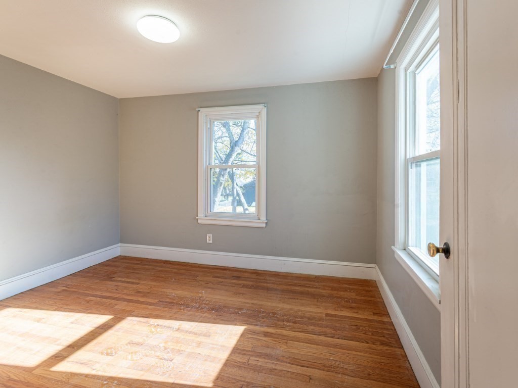 19 Roosevelt Avenue Springfield, MA 01118 - Photo 16 of 27 an empty room with wooden floor and windows