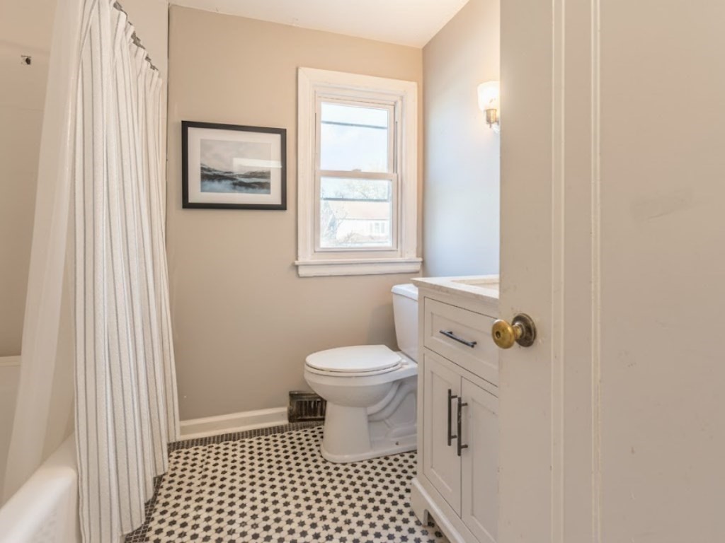 19 Roosevelt Avenue Springfield, MA 01118 - Photo 18 of 27 a bathroom with a sink a toilet and a window