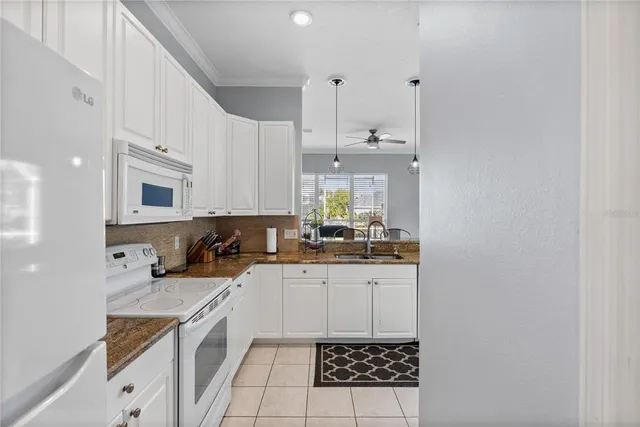 a kitchen with stainless steel appliances a sink a stove a microwave and cabinets
