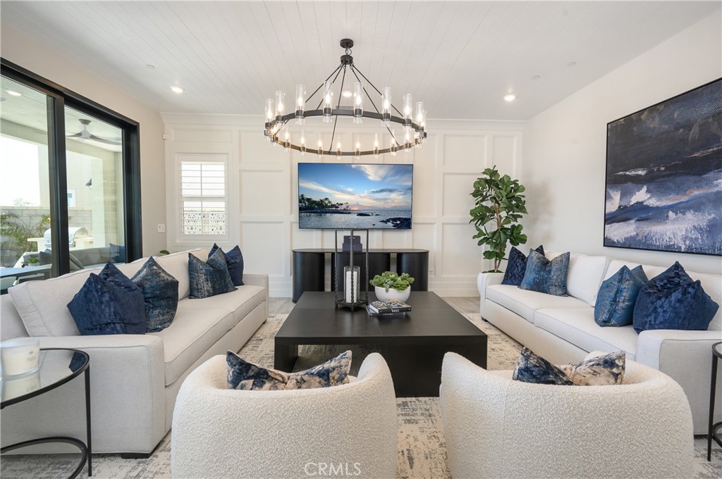 13093 Edgware Drive Rancho Cucamonga, CA 91739 - Photo 6 of 25 a living room with furniture a chandelier and a fireplace
