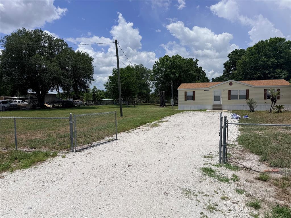 33 Ridge Road Frostproof, FL 33843 - Photo 3 of 21 a view of a house with a backyard
