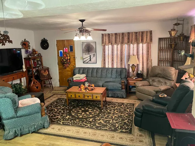 a living room with furniture and a chandelier