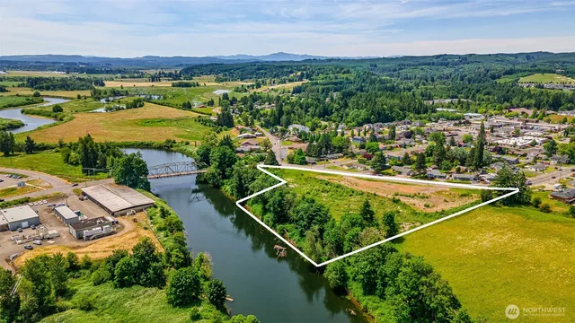 an aerial view of residential houses with outdoor space and river