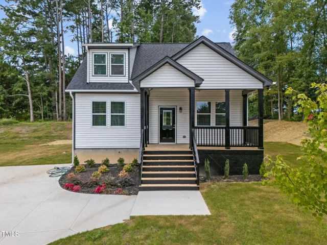 a front view of a house with a garden