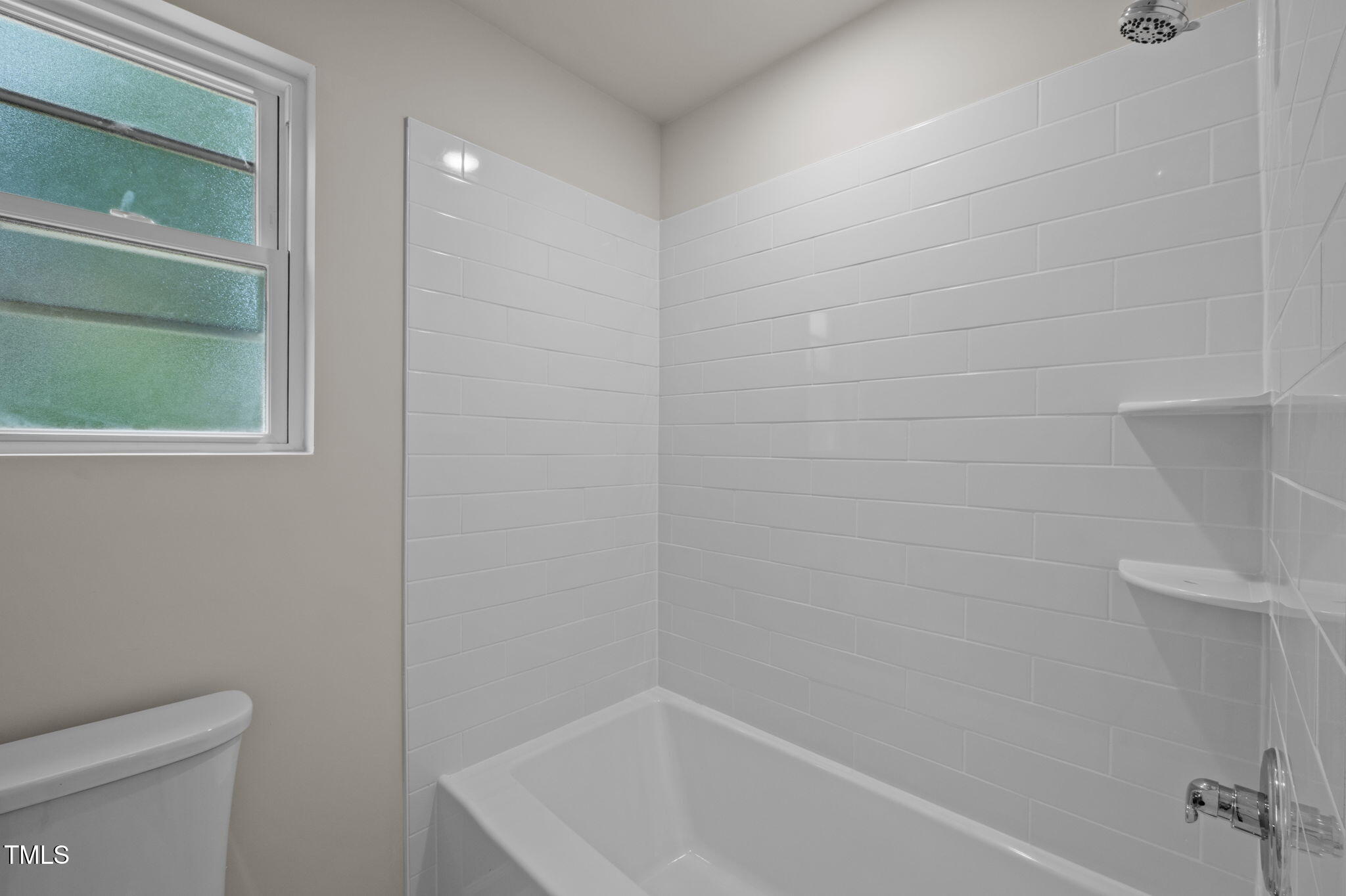 525 North Hoover Road Durham, NC 27703 - Photo 17 of 45 a bathroom with a bathtub and a toilet