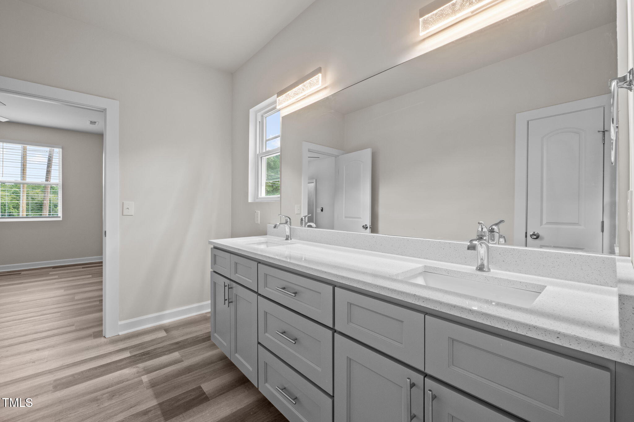 525 North Hoover Road Durham, NC 27703 - Photo 18 of 45 a bathroom with a double vanity sink and a mirror