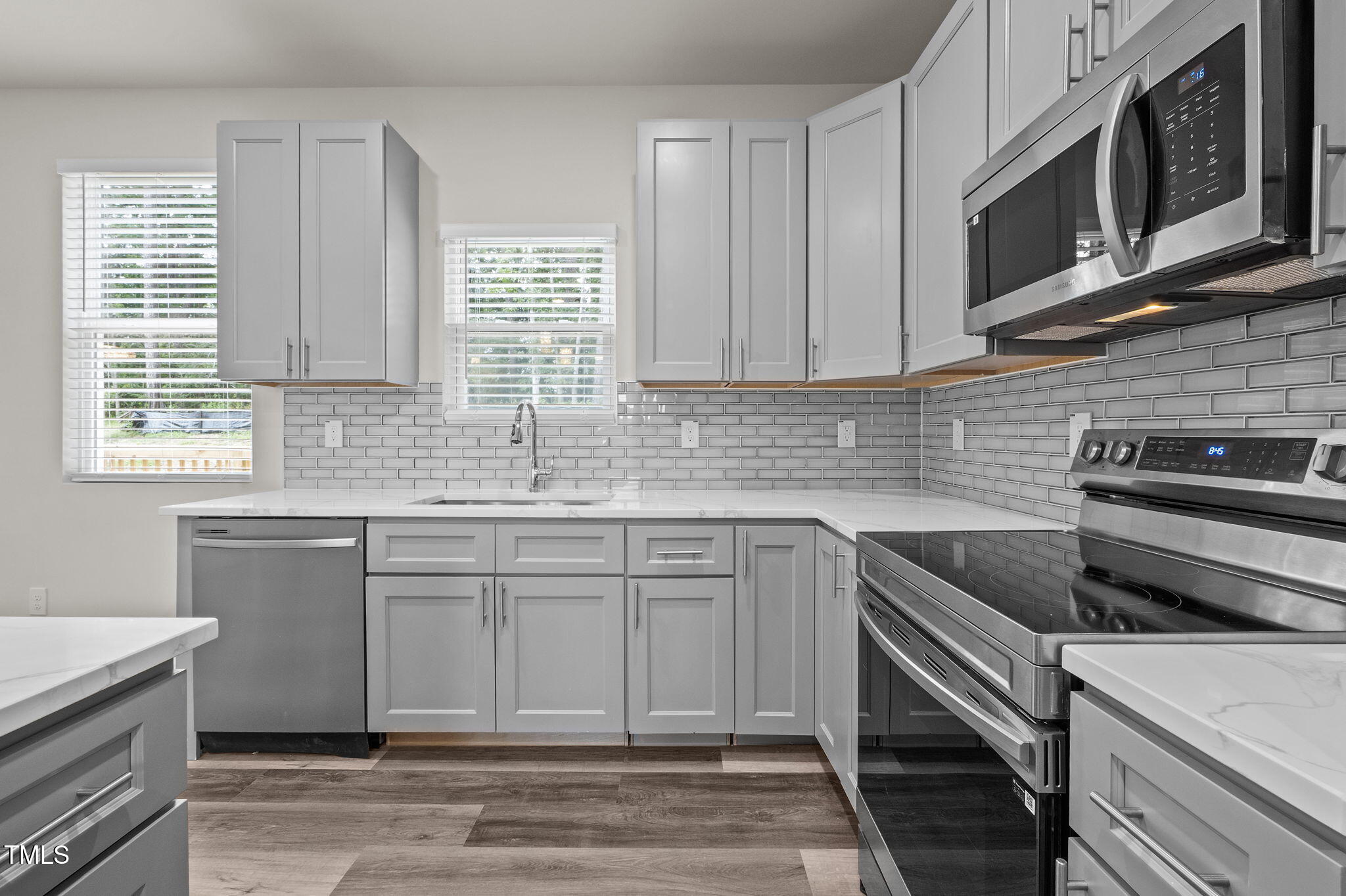 525 North Hoover Road Durham, NC 27703 - Photo 22 of 45 a kitchen with stainless steel appliances granite countertop a sink a stove a microwave and cabinets
