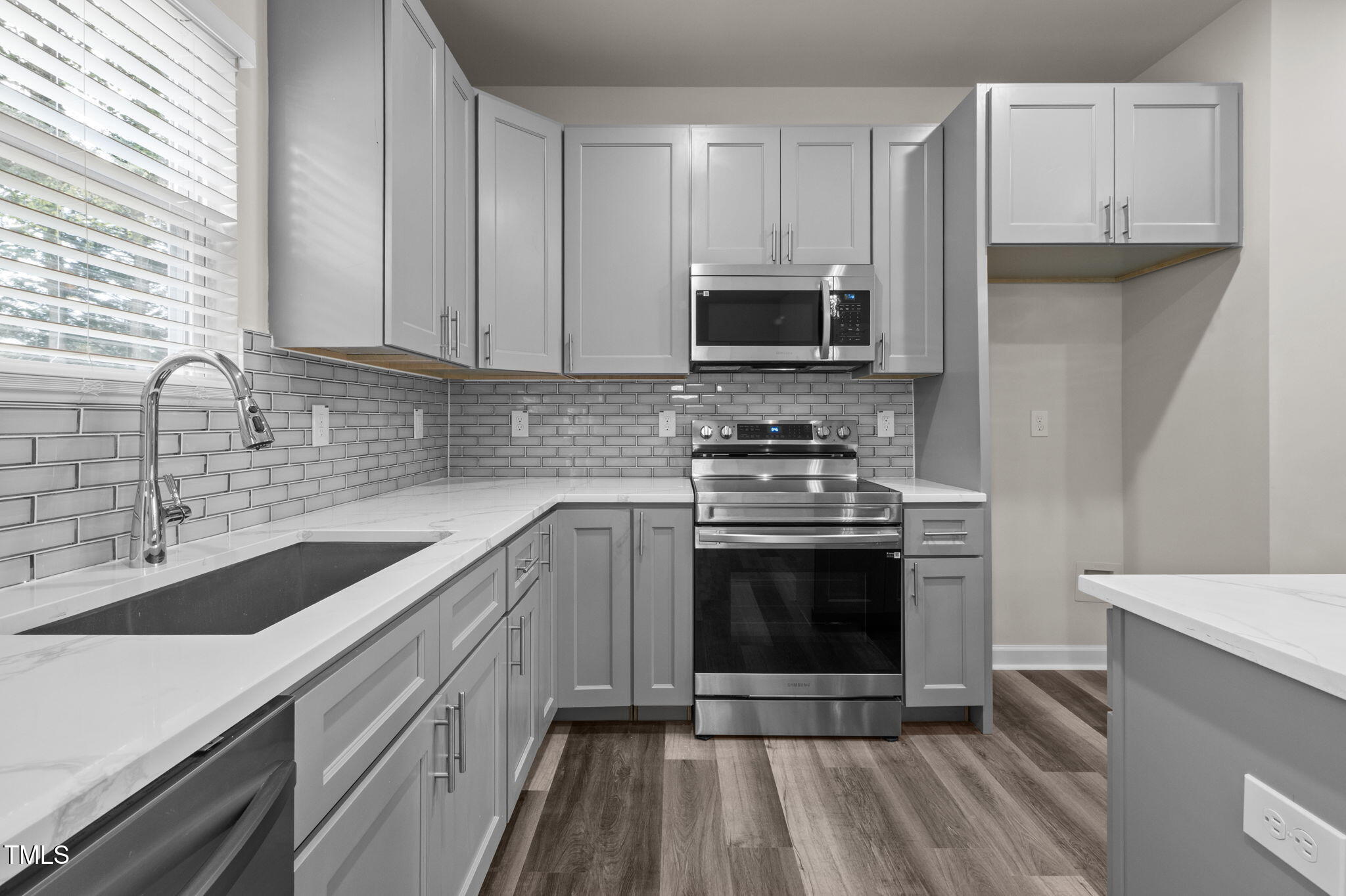525 North Hoover Road Durham, NC 27703 - Photo 23 of 45 a kitchen with stainless steel appliances granite countertop a sink stove and microwave