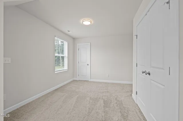 a bathroom with a window and a shower
