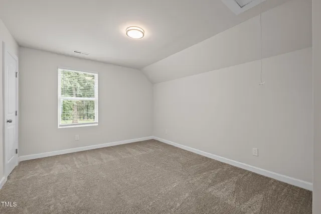 a view of an empty room and closet area