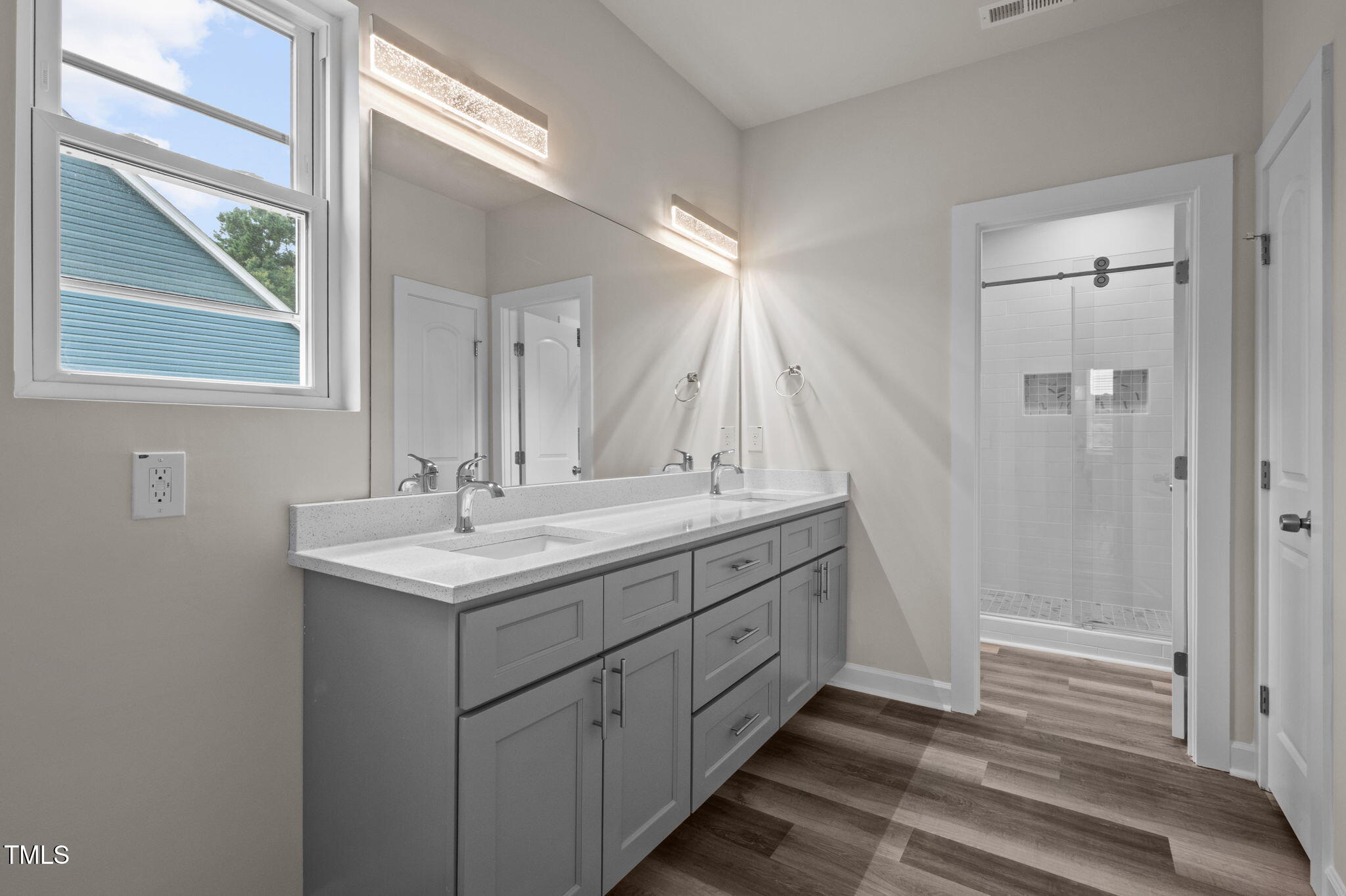 525 North Hoover Road Durham, NC 27703 - Photo 38 of 45 a bathroom with a double vanity sink and mirror