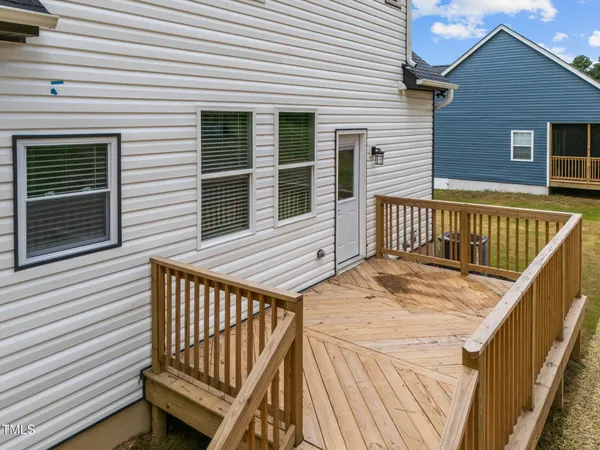 a view of a wooden deck with a barbeque