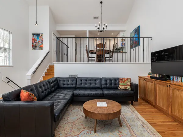a living room with furniture a rug and a chandelier