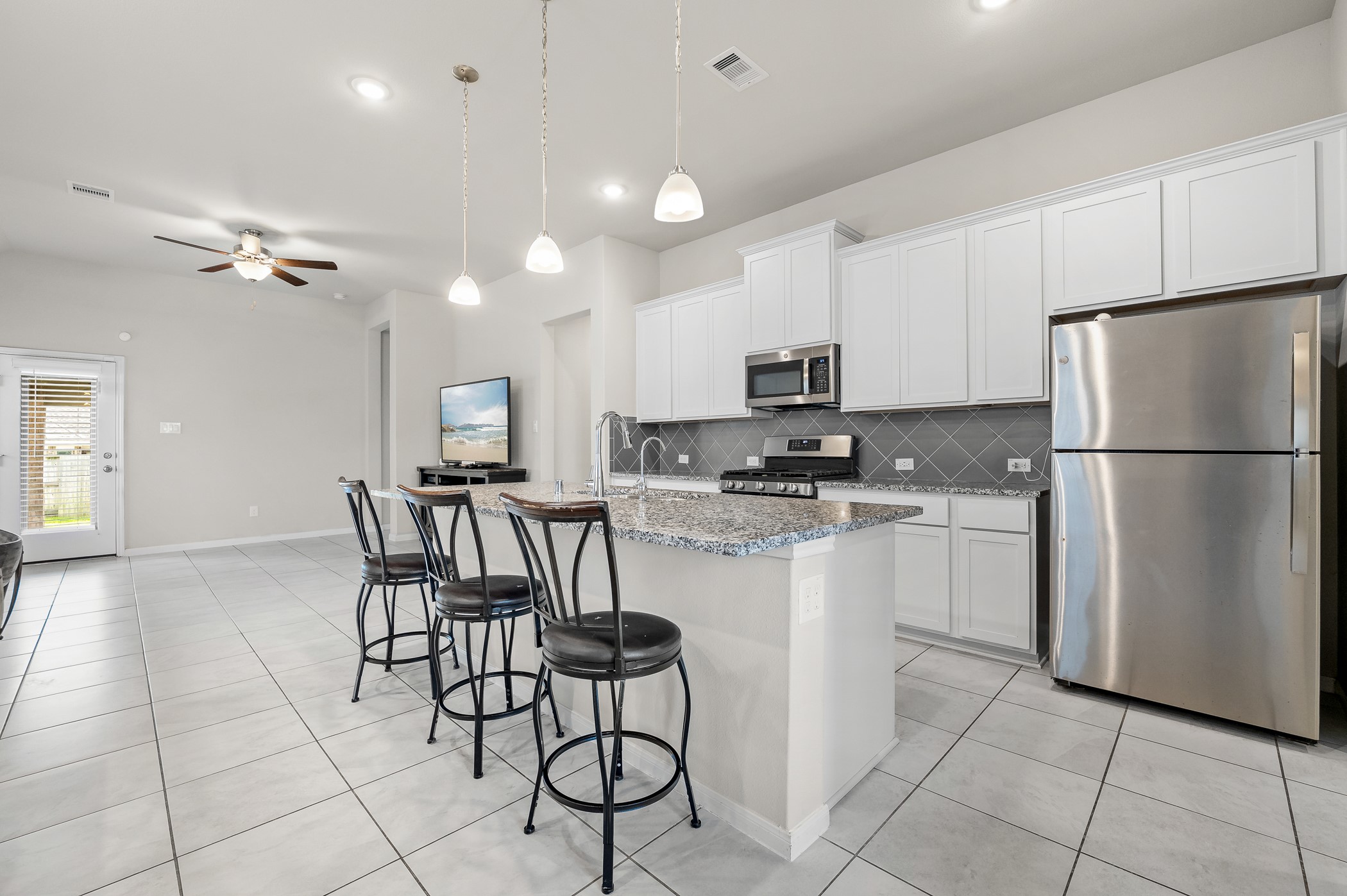 3722 Amoroso Drive Rosharon, TX 77583 - Photo 8 of 27 a kitchen with stainless steel appliances a refrigerator sink and cabinets