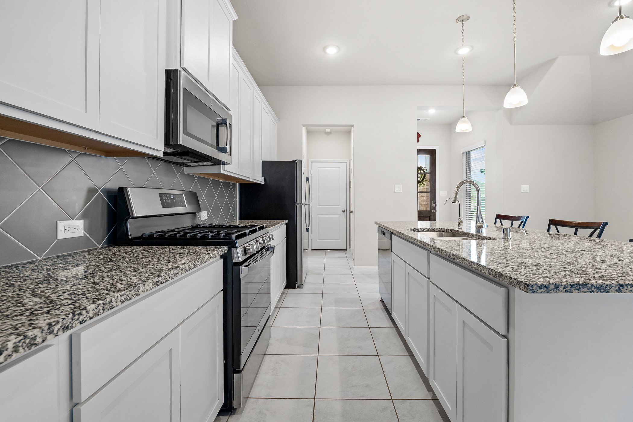 3722 Amoroso Drive Rosharon, TX 77583 - Photo 10 of 27 a kitchen with stainless steel appliances granite countertop a sink stove and cabinets