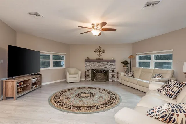 a view of a a dining room with furniture window and wooden floor