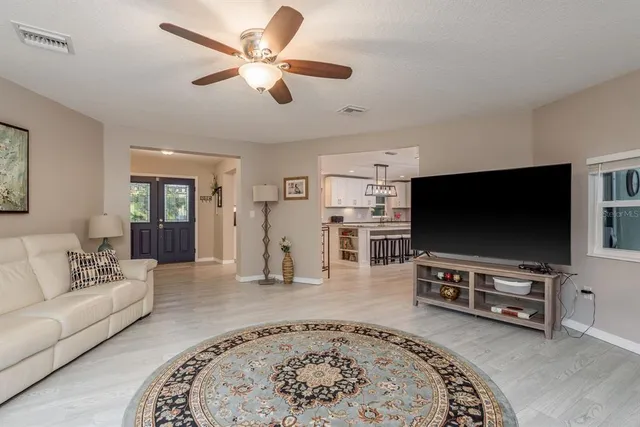 a view of a dining room with furniture and a chandelier
