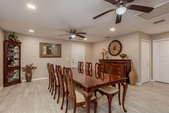 a view of a hallway with wooden floor and closet