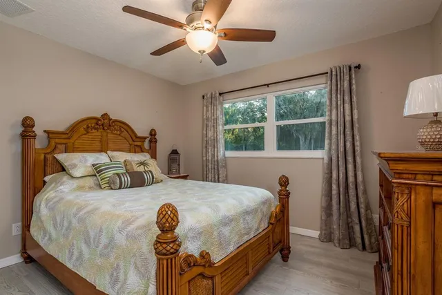 a bedroom with a large bed and a chandelier