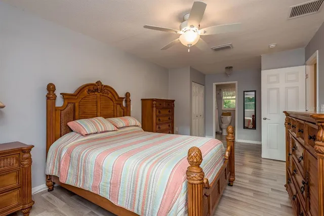a dining room with furniture large windows and a chandelier