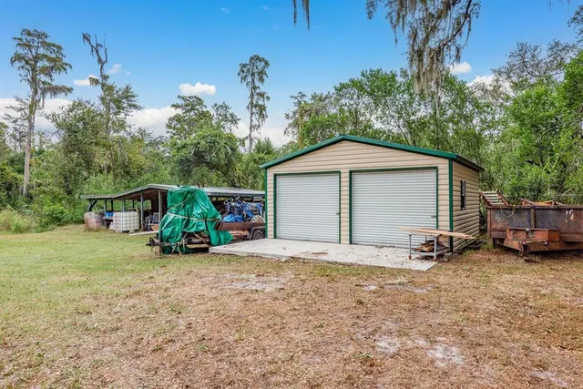 a front view of house with a garden