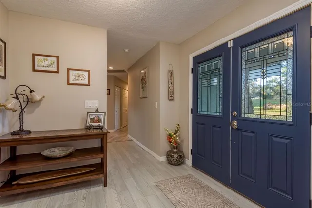 a kitchen with stainless steel appliances granite countertop a stove oven a dining table and chairs with wooden floor