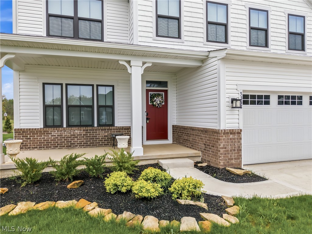 5358 Walnut Rdg Lane Sheffield Lake, OH 44054 - Photo 4 of 50 White siding facade with a contrasting red front door and black-framed windows