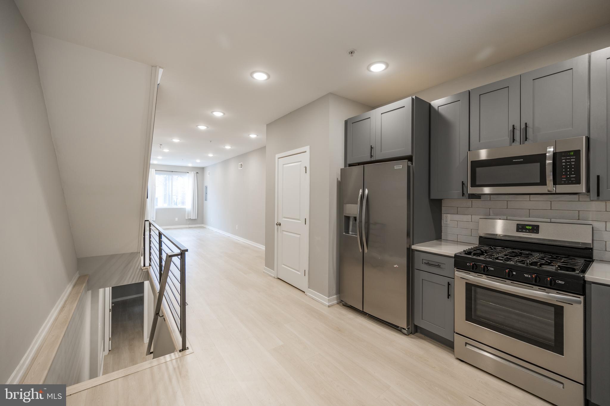 2428 Jasper Street, Unit A Philadelphia, PA 19125 - Photo 1 of 26 a kitchen with stainless steel appliances granite countertop a refrigerator stove and microwave