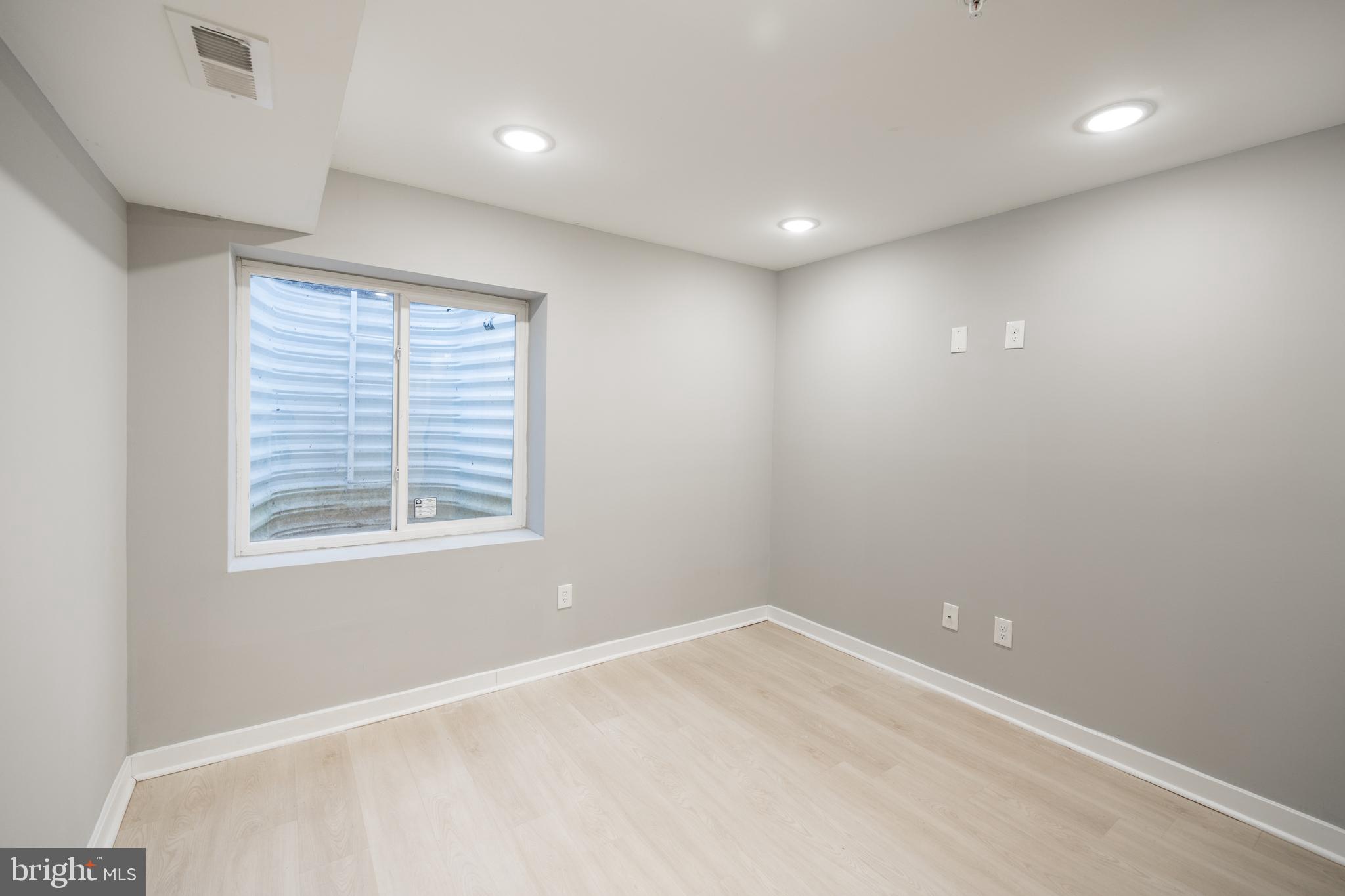 2428 Jasper Street, Unit A Philadelphia, PA 19125 - Photo 15 of 26 an empty room with a window