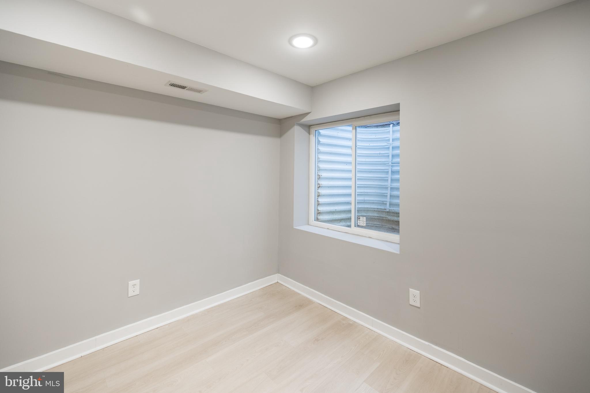 2428 Jasper Street, Unit A Philadelphia, PA 19125 - Photo 16 of 26 a view of an empty room with a window