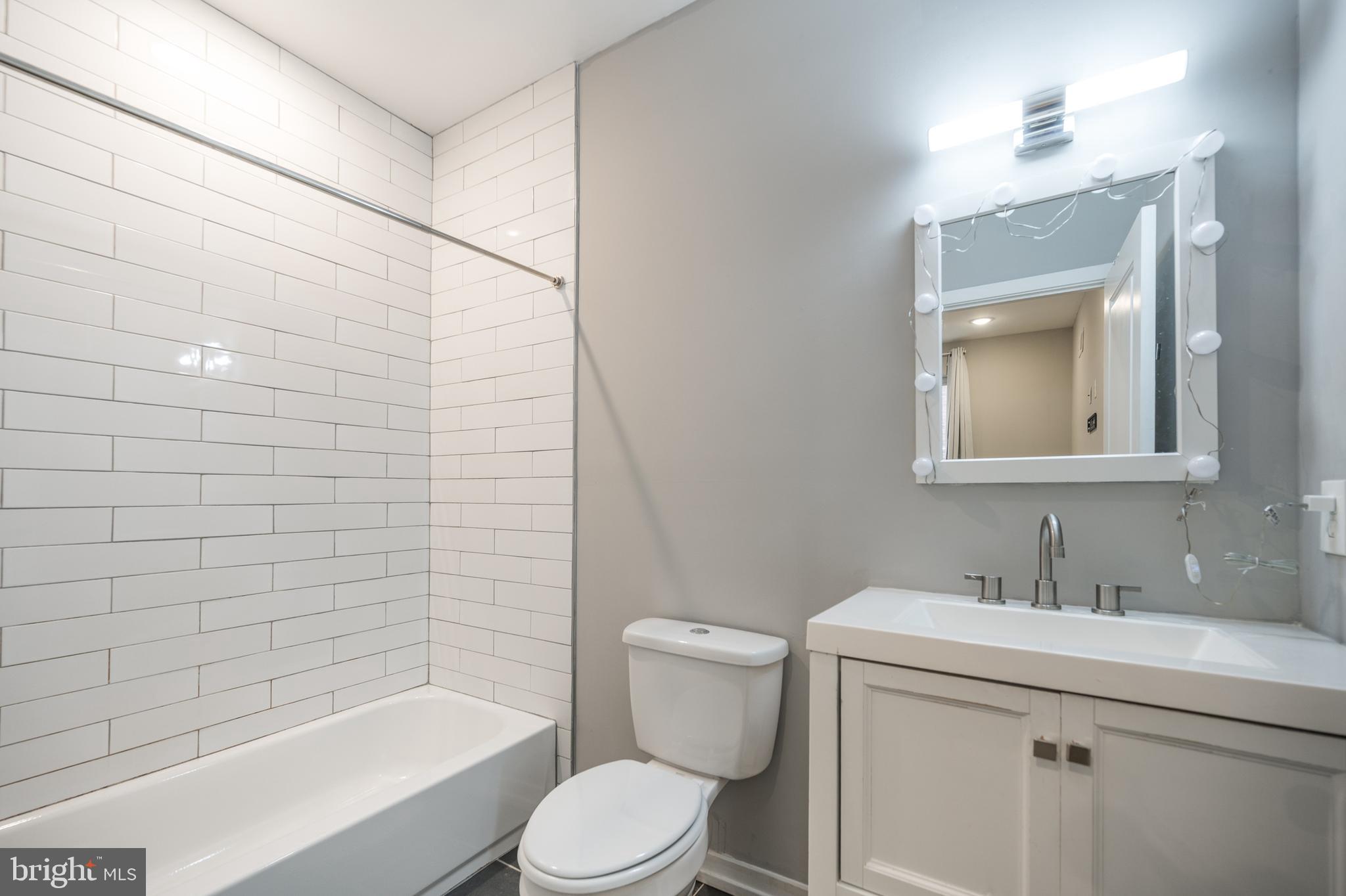 2428 Jasper Street, Unit A Philadelphia, PA 19125 - Photo 23 of 26 a bathroom with a sink toilet and shower