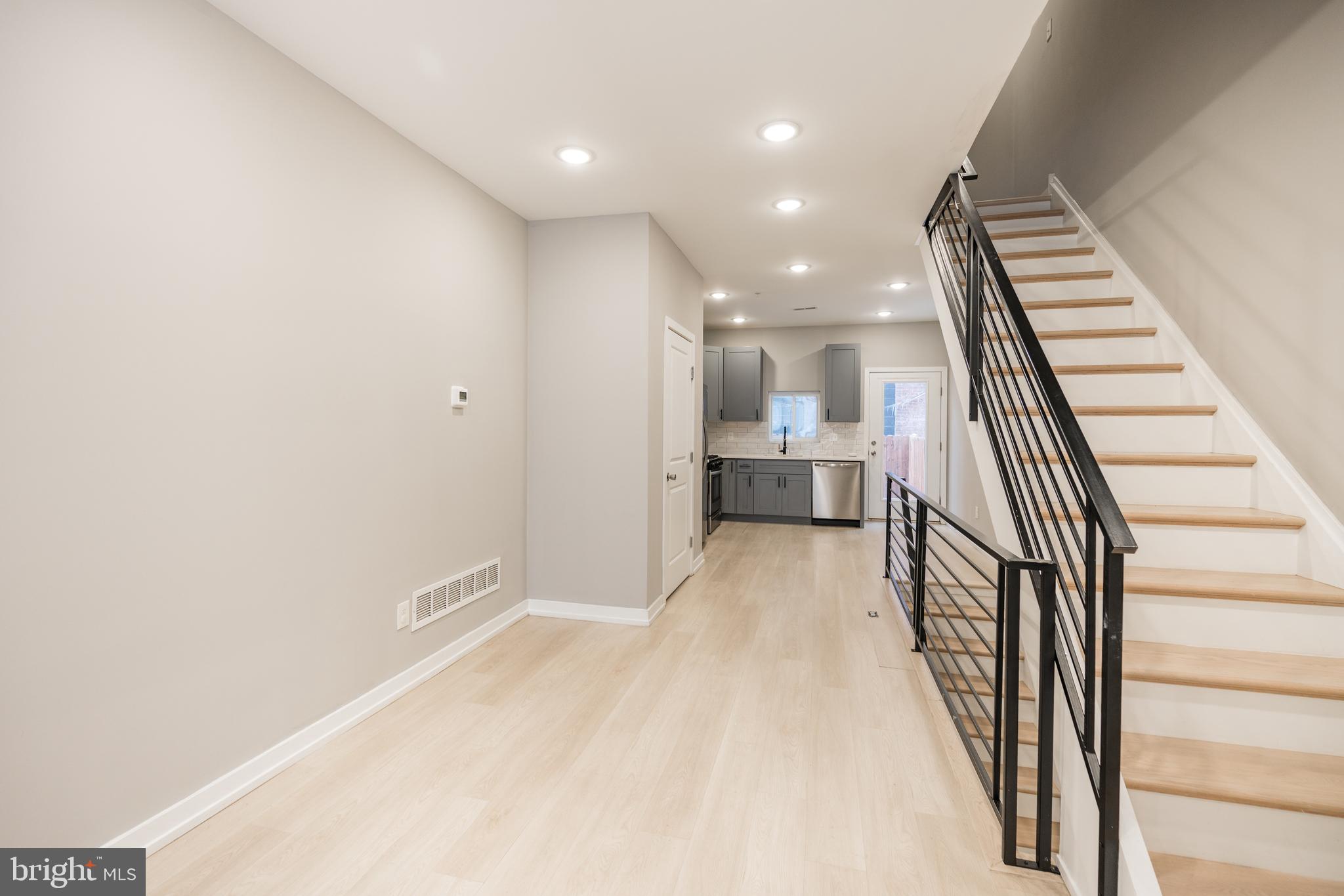 2428 Jasper Street, Unit A Philadelphia, PA 19125 - Photo 5 of 26 a view of kitchen and hall with wooden floor