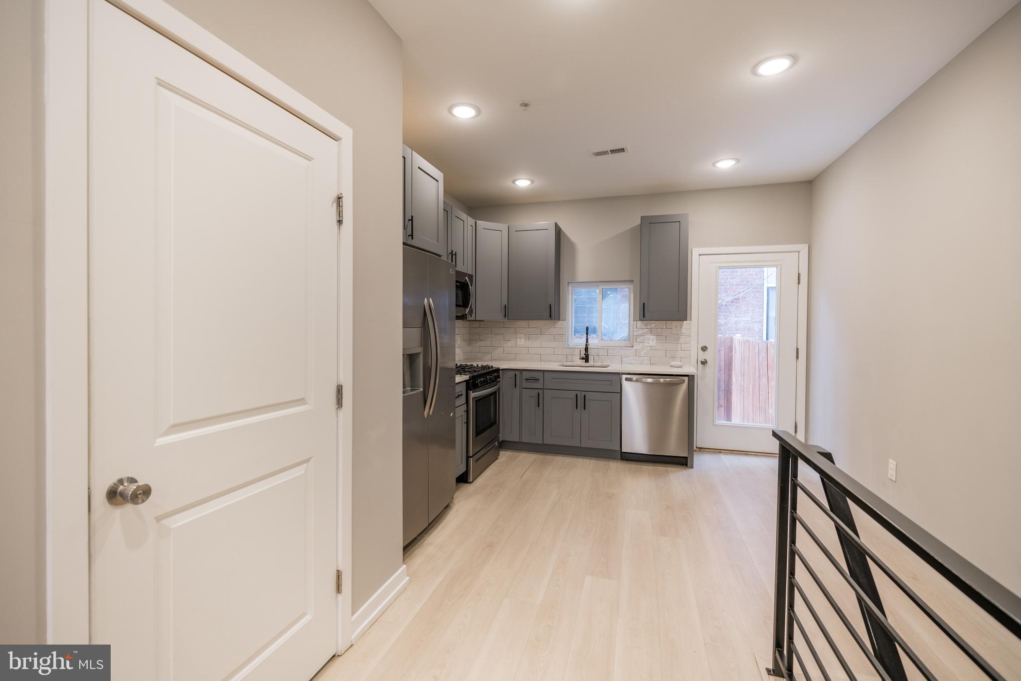 2428 Jasper Street, Unit A Philadelphia, PA 19125 - Photo 8 of 26 a kitchen with a sink stainless steel appliances cabinets and a counter top space
