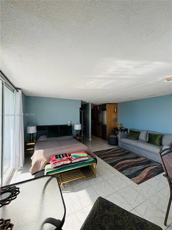 a bedroom with a bed and a potted plant