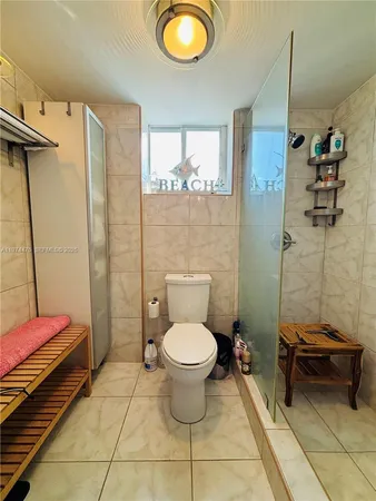 a bathroom with a toilet and a shower