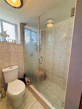 a bathroom with a toilet and a shower