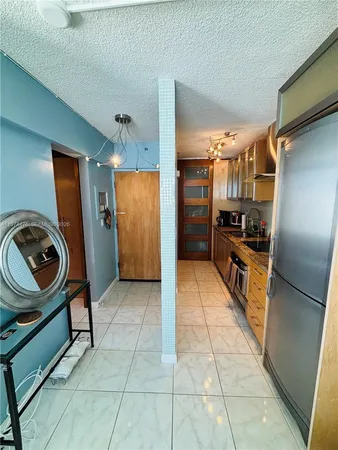 a kitchen with stainless steel appliances granite countertop a refrigerator and a stove top oven