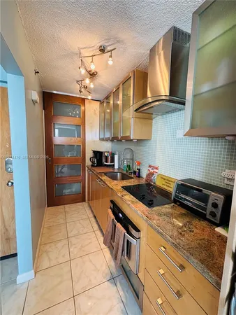 a kitchen with stainless steel appliances granite countertop a stove and cabinets