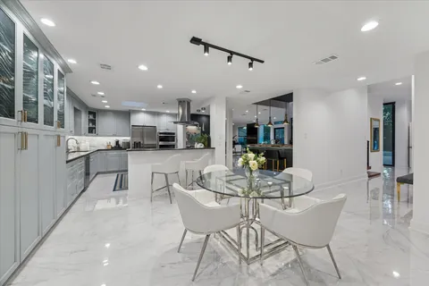 a kitchen with stainless steel appliances kitchen island granite countertop a sink and cabinets