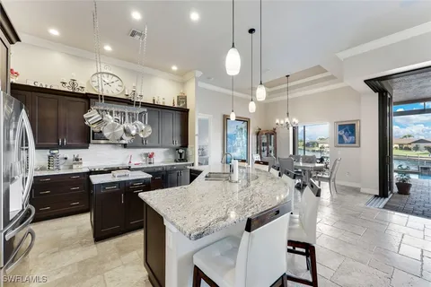 a kitchen with lots of counter top space a sink appliances and cabinets