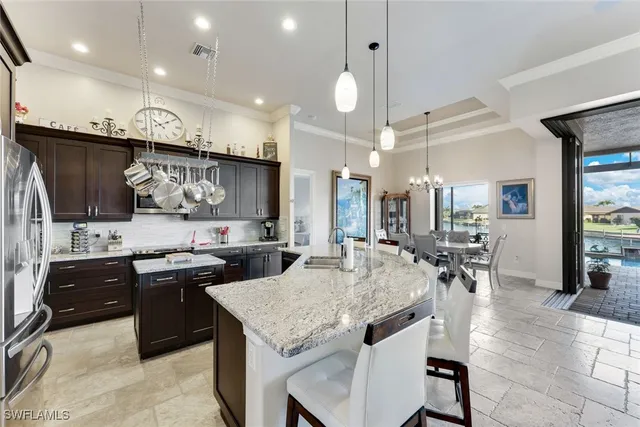 a kitchen with lots of counter top space a sink appliances and cabinets