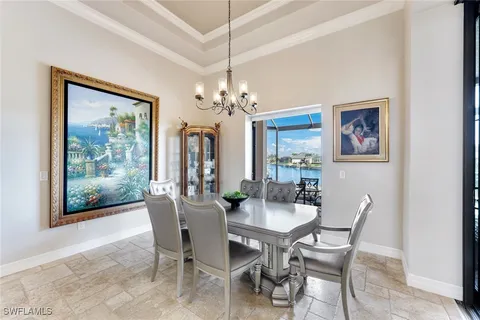 a dining room with furniture a painting and a chandelier