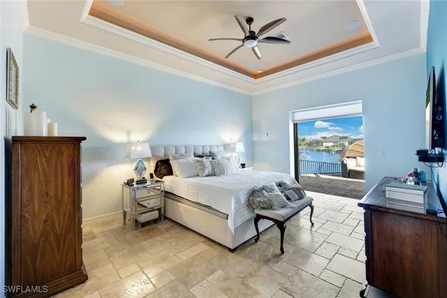 a spacious bedroom with a bed and wooden floor