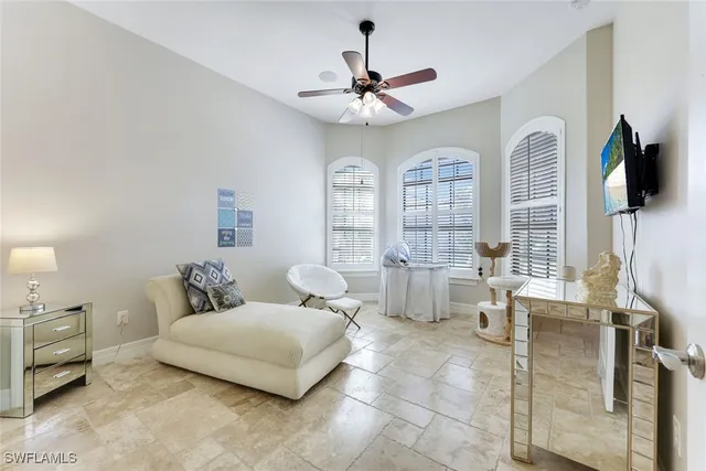 a living room with furniture a large window and a chandelier