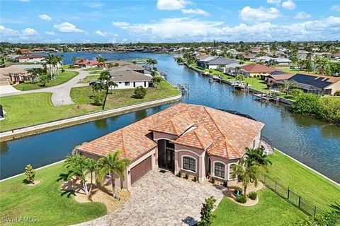 an aerial view of residential houses with outdoor space and lake view