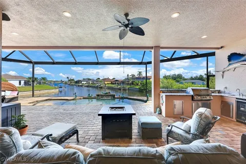 a living room with furniture a fireplace and a floor to ceiling window