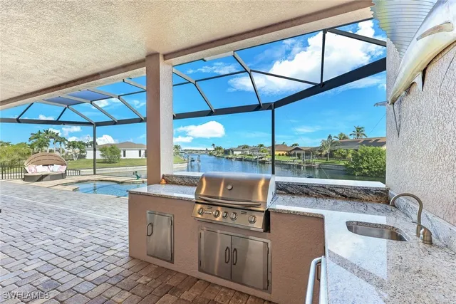 a kitchen with stainless steel appliances granite countertop a sink and a table