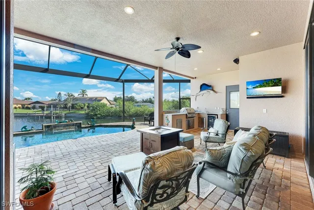 a living room with furniture and a floor to ceiling window